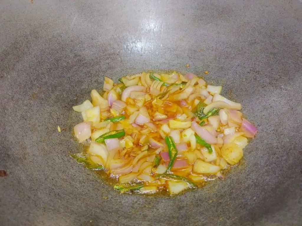 Now add chopped onion. Mix everything well and sauté until the onion becomes soft and light golden.