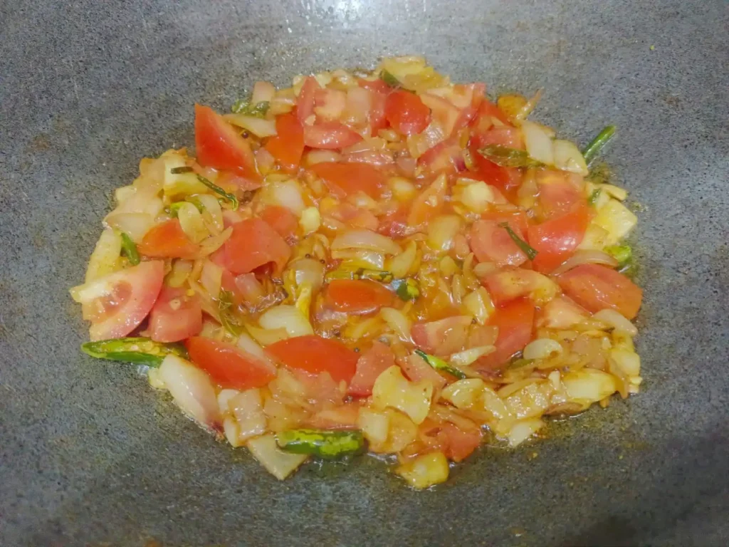 Now add chopped tomato and add salt as per your taste. Cook for 2-3 minutes until the tomato turns soft and blends well with the masala.
