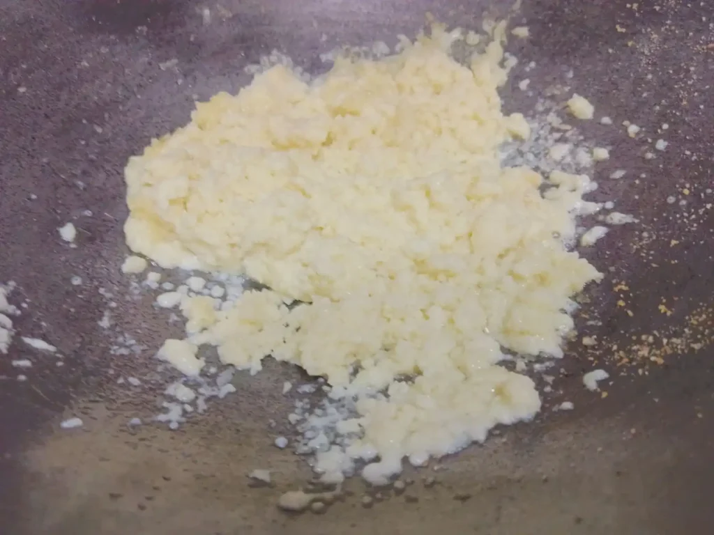 4: Now add khoya into the same pan and on low heat cook to light brown.