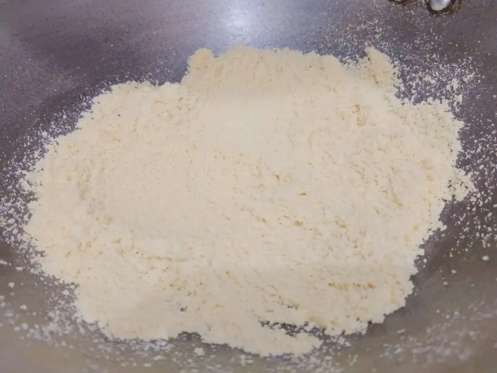 3: Next in the same pan, add 4-5 tsp of ghee and roast semolina (suji) until light golden brown. Transfer to a bowl and allow to cool.