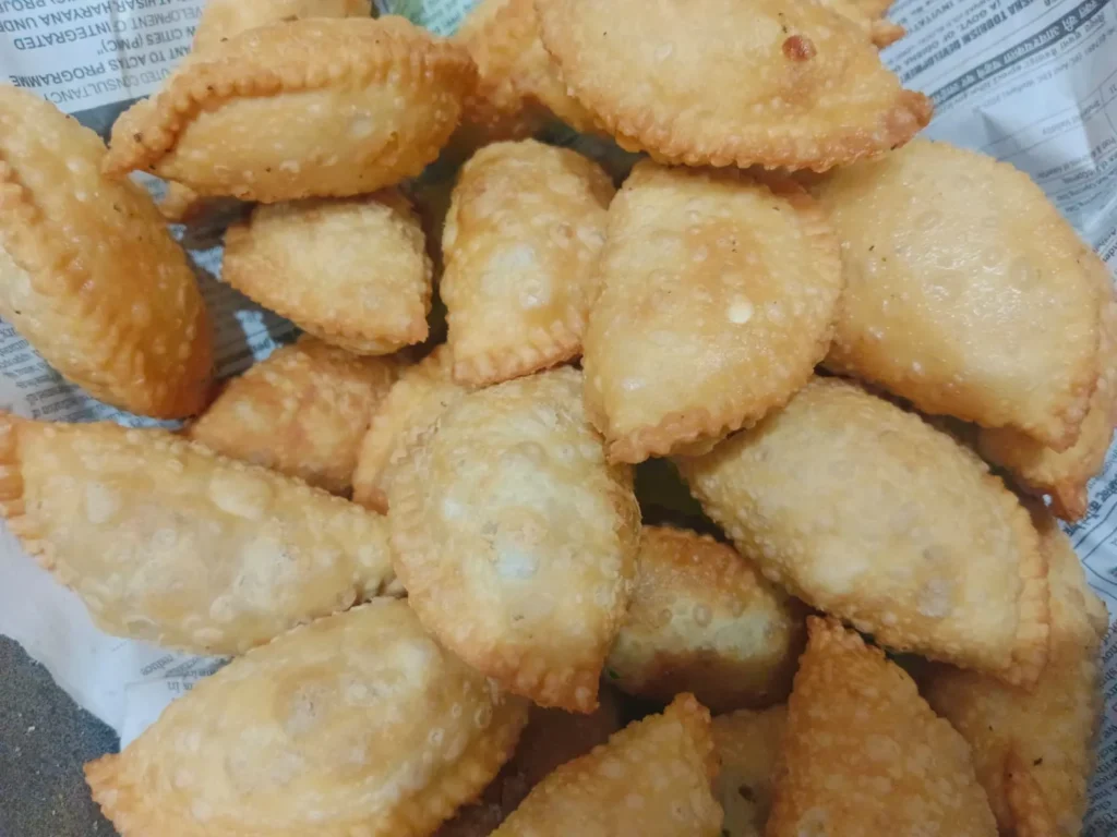 5. After they have browned, take them out and allow them to cool for a little bit. Now gujiya sweets are ready. Then, enjoy your yummy homemade gujiya sweet.