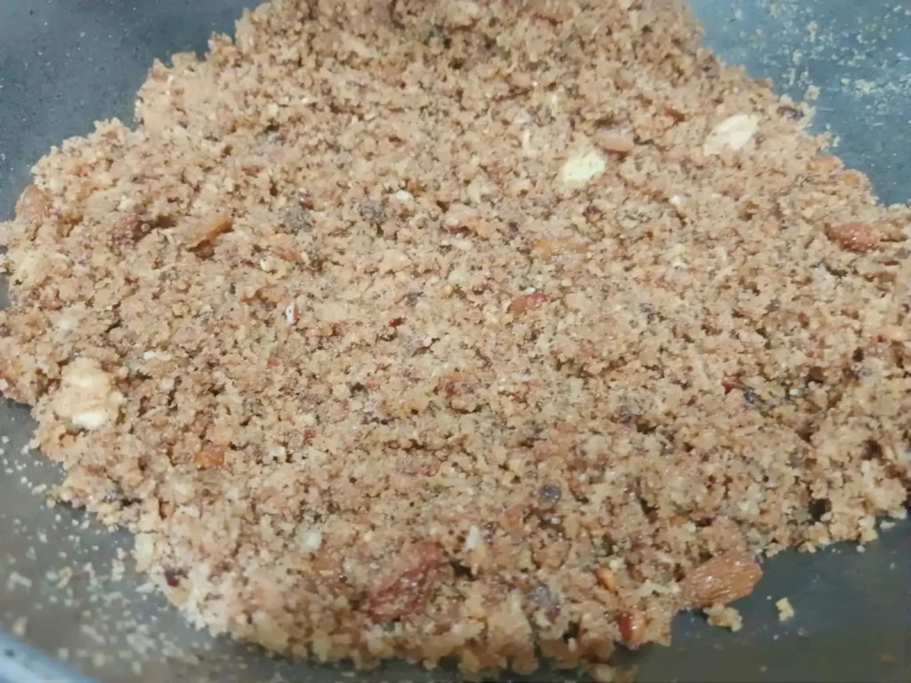 6: Once the mixture has cooled add a little ground khoya along with a half glass of milk. Milk should only be used when preparing the filling so that it remains soft and moist.