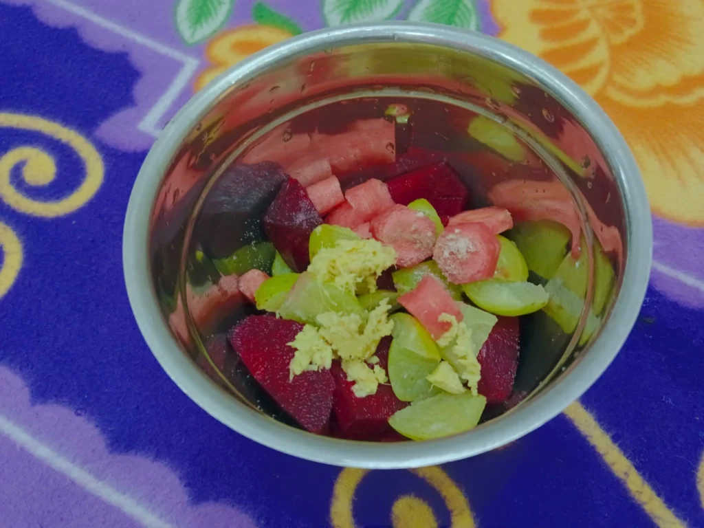 Add the chopped amla, beetroot, carrot, ginger, black salt, and water to the blender.